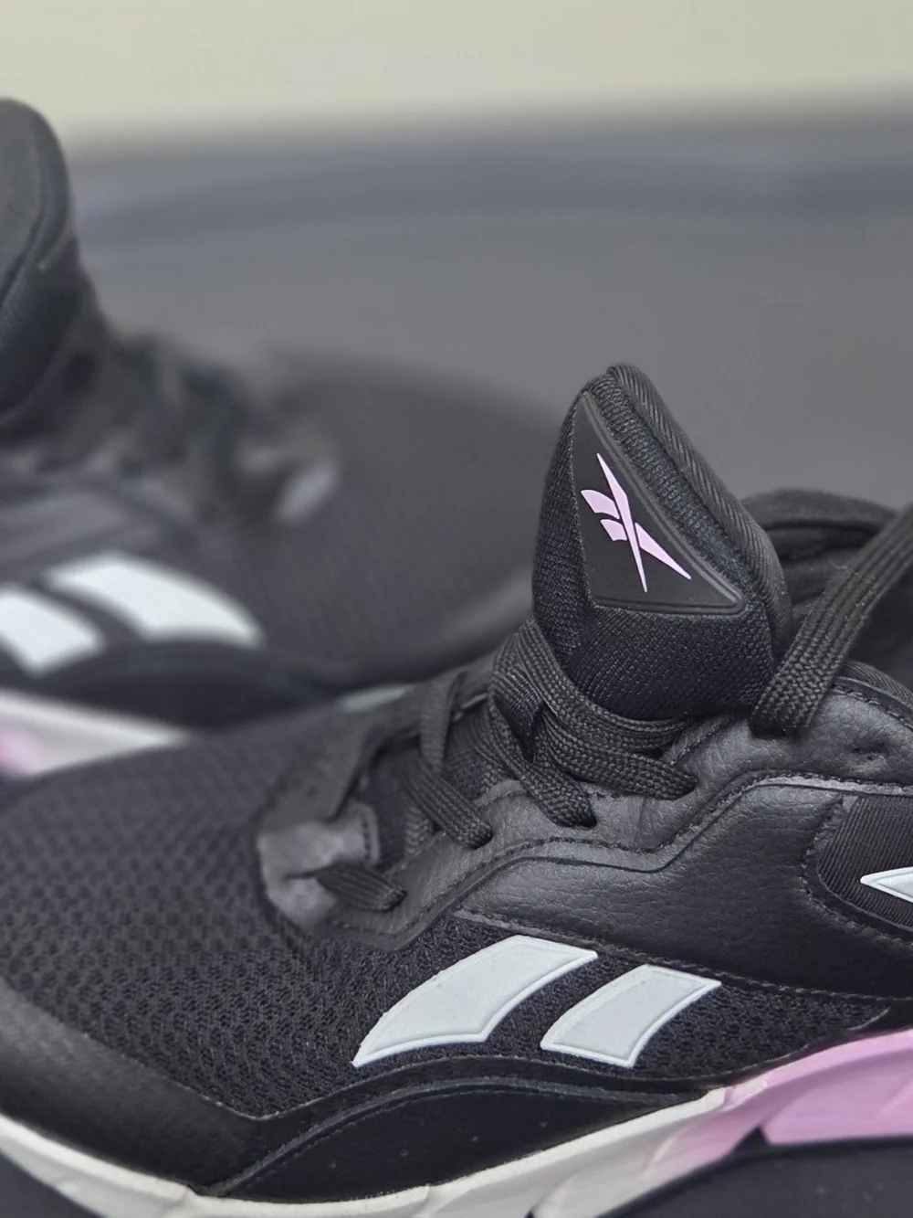 Reebok Black Athletic Sneakers with White Stripes and Pink Logo